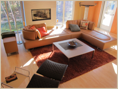 The living area, bathed in the morning sunshine, as viewed from the kitchen.