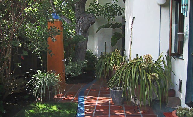 new side court design with outdoor shower as free standing obelisk 